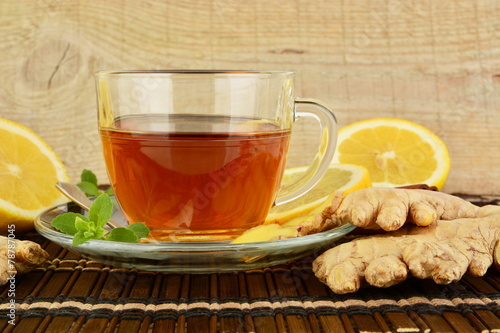 Ginger tea-ingwertee on brown mat with lemon