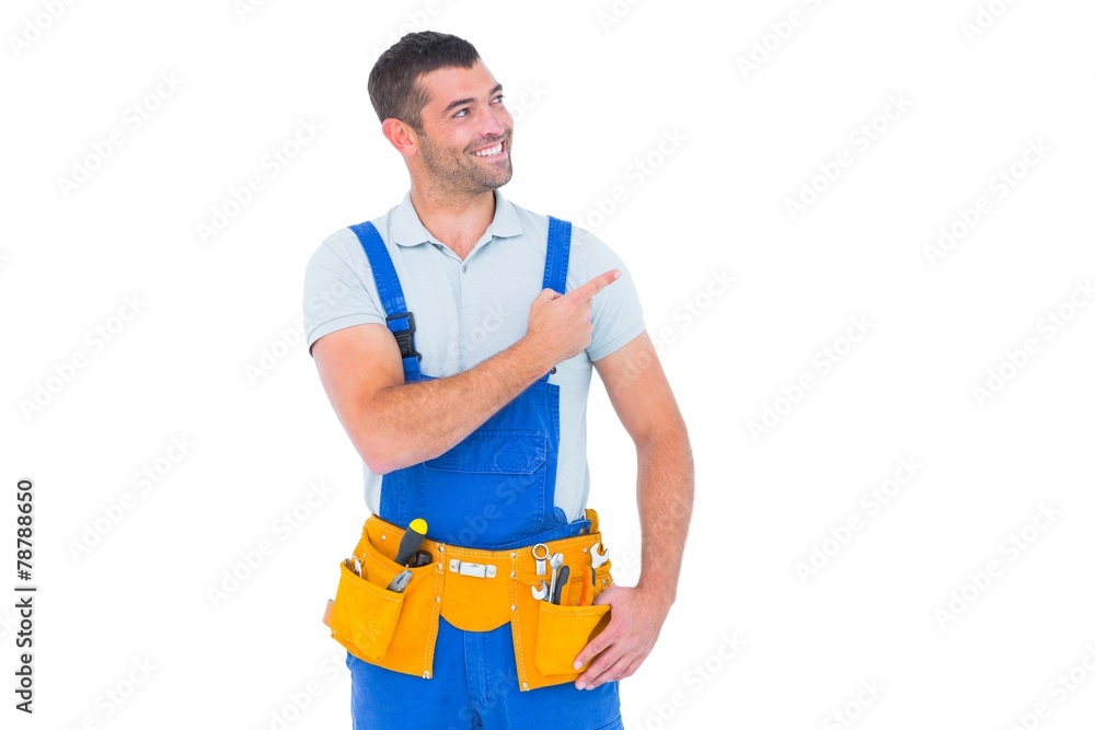 Repairman in overalls pointing on white background Repairman in overalls pointing on white background
