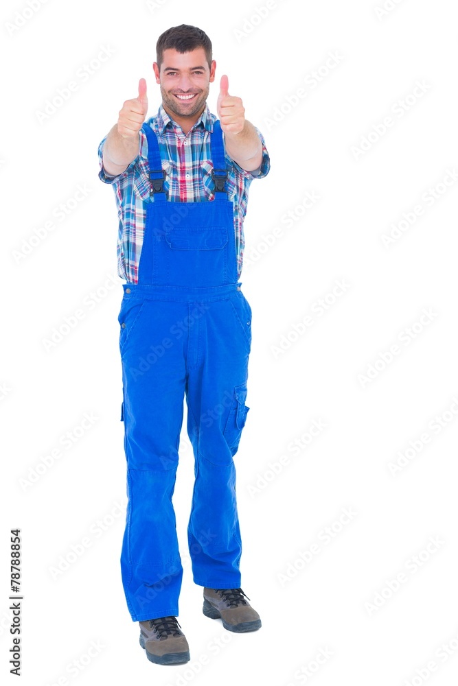 Happy handyman in coveralls gesturing thumbs up Happy handyman in coveralls gesturing thumbs up