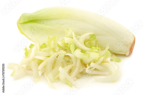 fresh whole chicory and some pieces on a white background