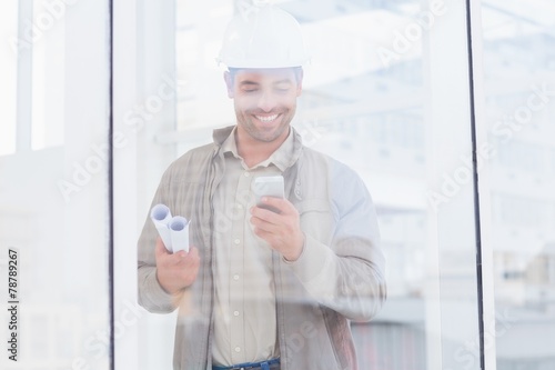 Architect using mobile phone in office