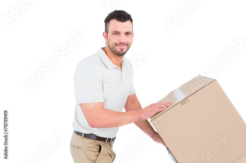 Delivery man pushing trolley of boxes