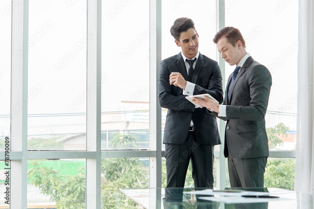 business partners discussing documents and ideas in office business partners discussing documents and ideas in office