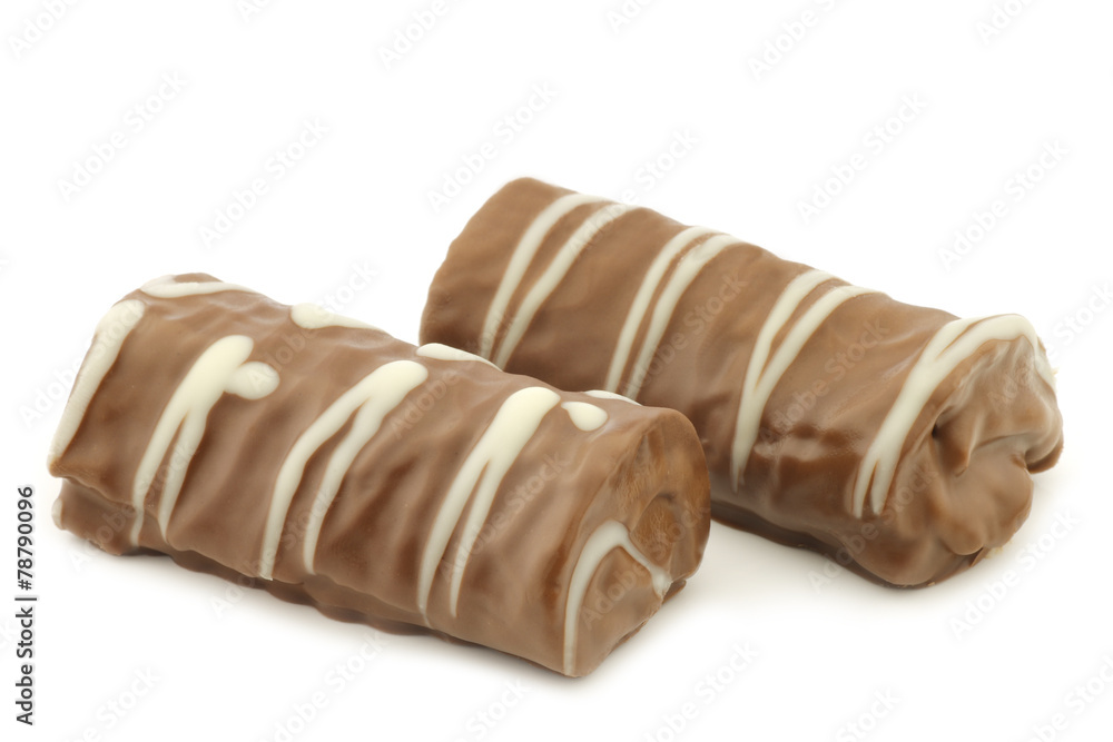 delicious chocolate and cake rolls and a cut one on a white back delicious chocolate and cake rolls and a cut one on a white back