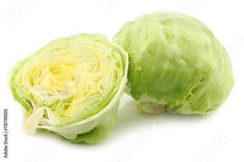 fresh iceberg lettuce and a cut one on a white background © tpzijl