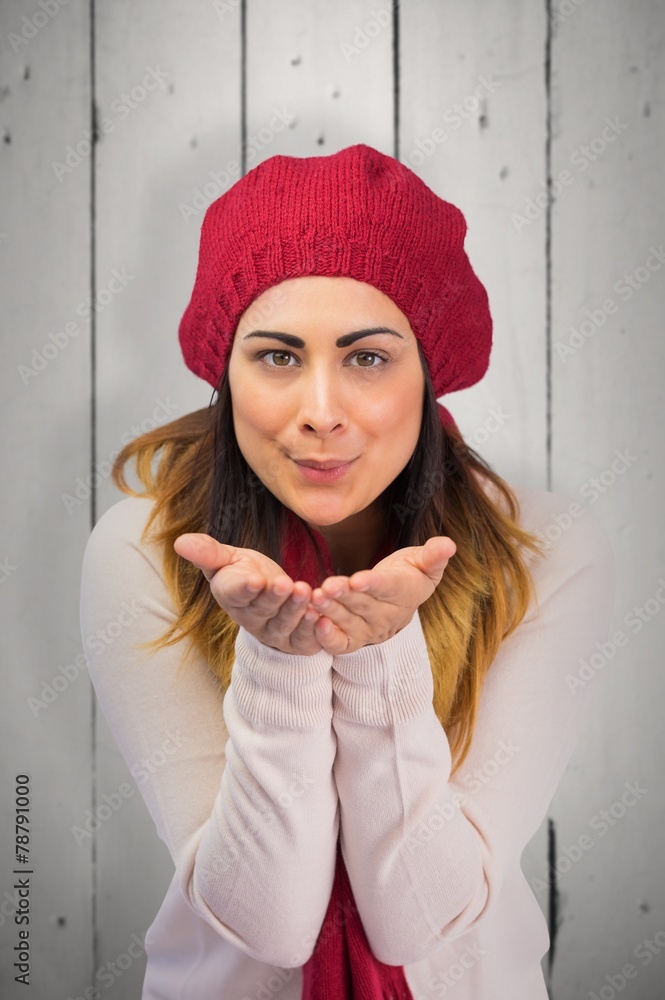 Composite image of brunette in winter clothes with hands out Composite image of brunette in winter clothes with hands out
