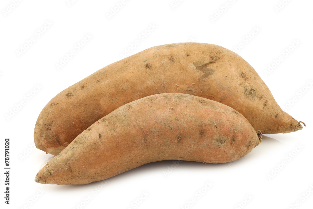 two whole sweet potatoes on a white background two whole sweet potatoes on a white background