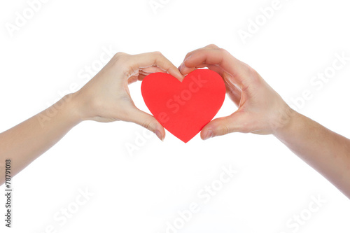 Couple in love holding a red paper heart in their hands