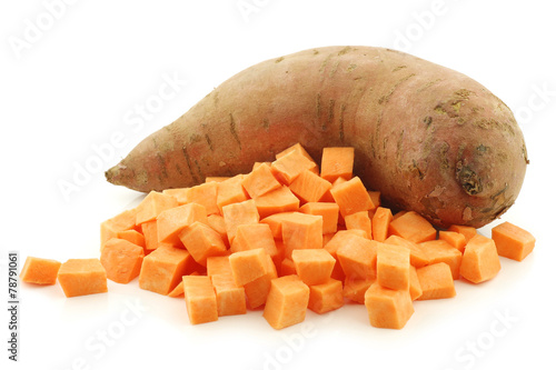 one whole sweet potato and cut blocks on a white background photo