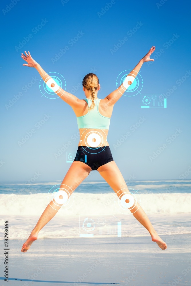 Composite image of fit woman jumping on the beach with arms out