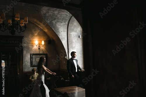 The bride and groom in a cozy house, photo taken with natural li © teksomolika