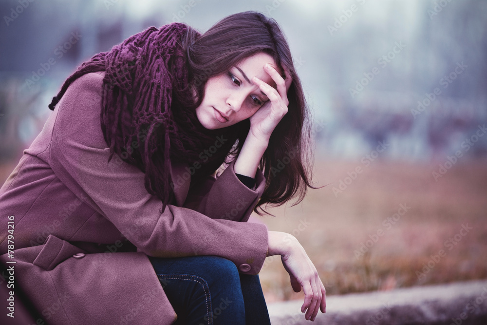 Sad Young Woman Sitting Outdoors - obrazy, fototapety, plakaty 