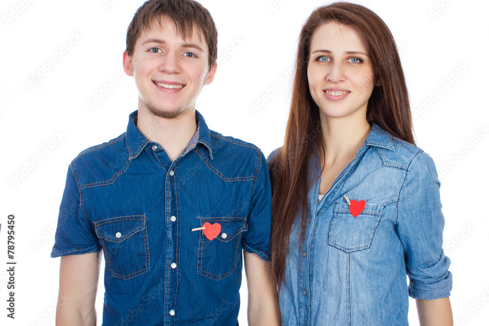 Miling couple standing with paper heart in pocket Miling couple standing with paper heart in pocket