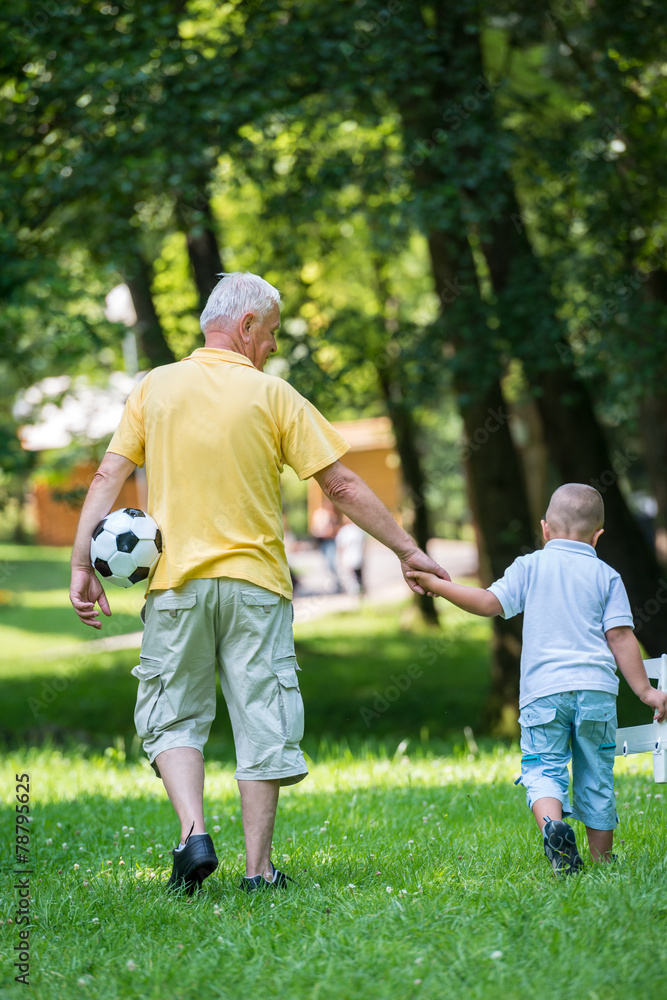 grandfather and child have fun in park grandfather and child have fun in park