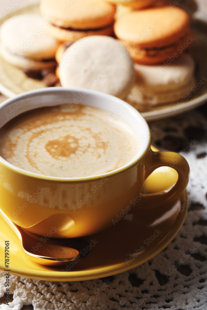Gentle colorful macaroons and coffee in mug Gentle colorful macaroons and coffee in mug