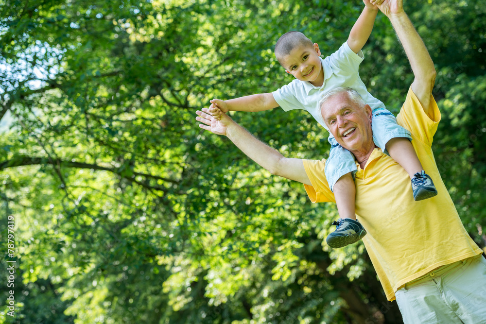 Fototapeta premium grandfather and child have fun in park