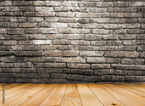 Maple wood floor with old brick wall background