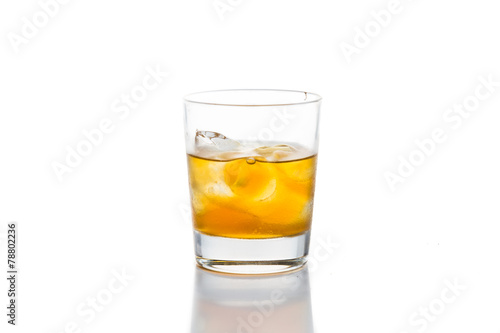 A glass of of Whiskey on the rocks against white background