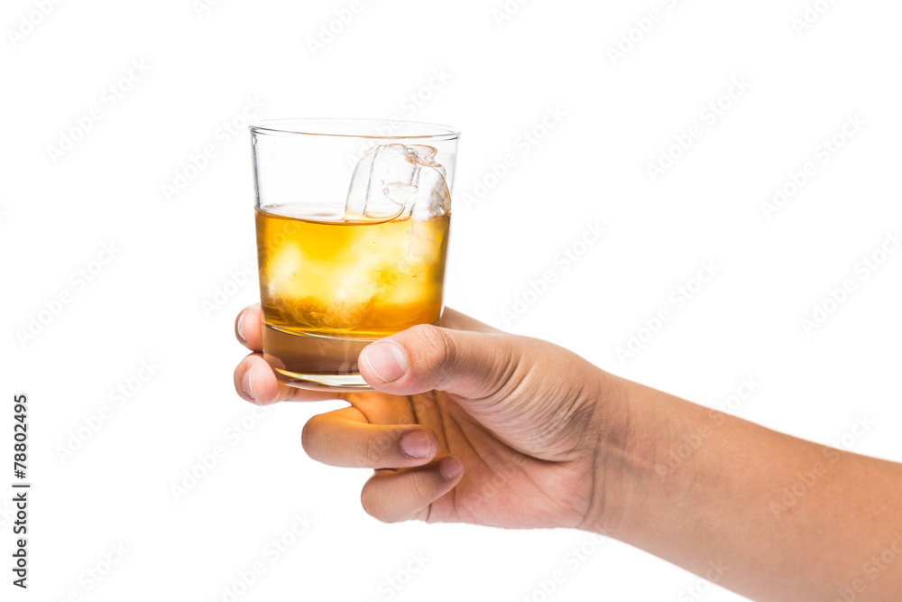 Hand holding a glass of whiskey on the rocks Hand holding a glass of whiskey on the rocks