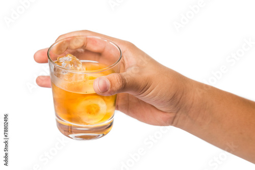 Hand holding a glass of whiskey on the rocks