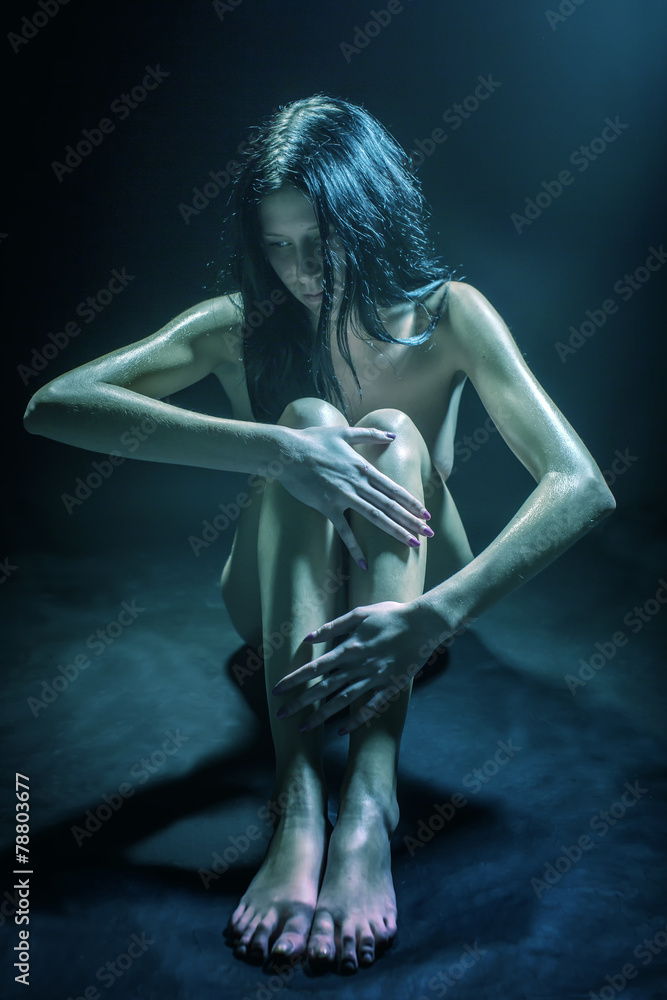 The naked woman on a black background The naked woman on a black background