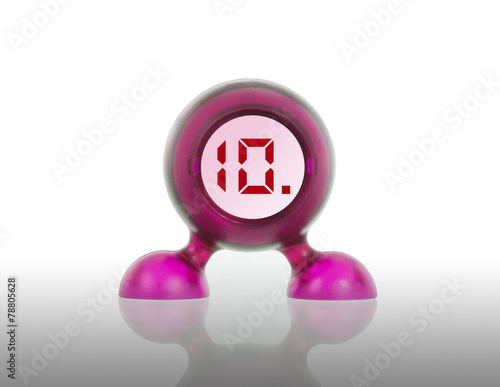 Small pink plastic object with a digital display