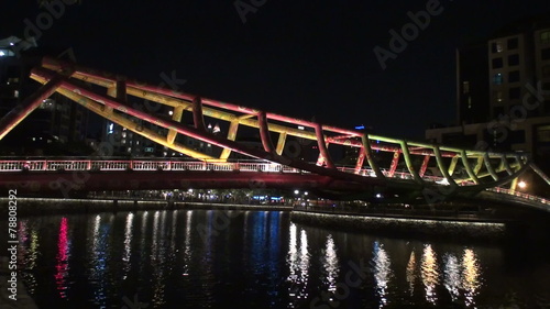 Modern bridge and city night lights reflecting on the river