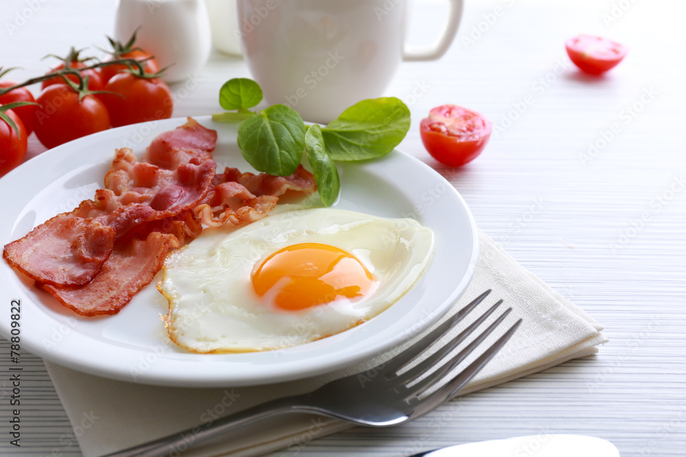 Bacon and eggs on color wooden table background Bacon and eggs on color wooden table background