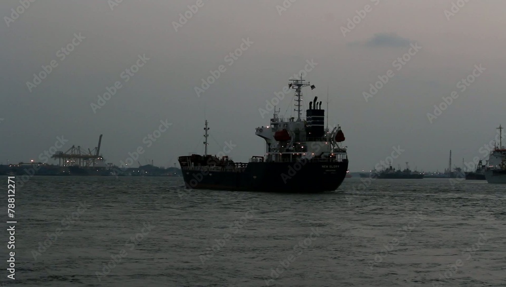 Cargo ship sails on sunset in Samutprakarn,Thailand Cargo ship sails on sunset in Samutprakarn,Thailand