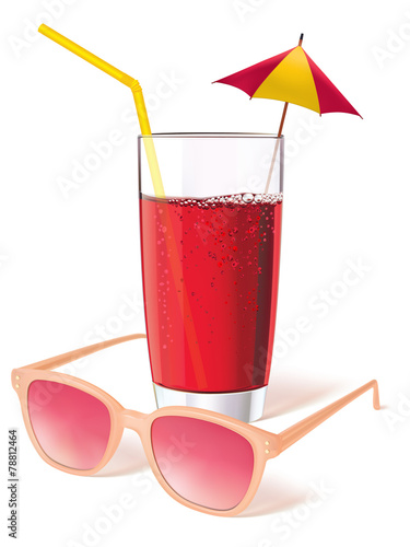 Glass with sunglasses, juice and decorated with a miniature umbr photo