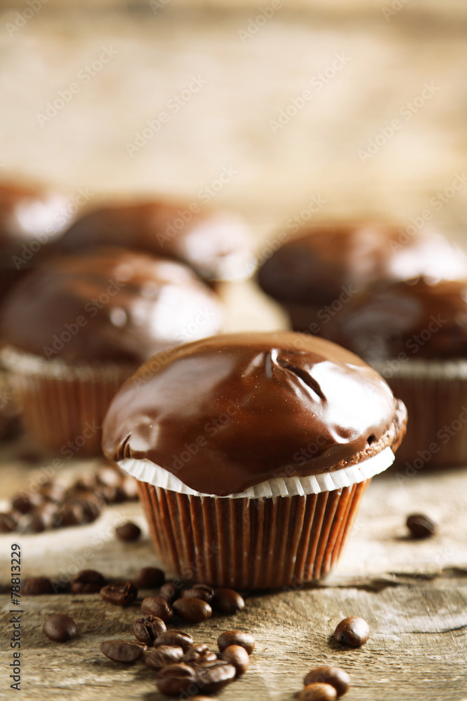 Tasty homemade chocolate muffins on wooden table Tasty homemade chocolate muffins on wooden table