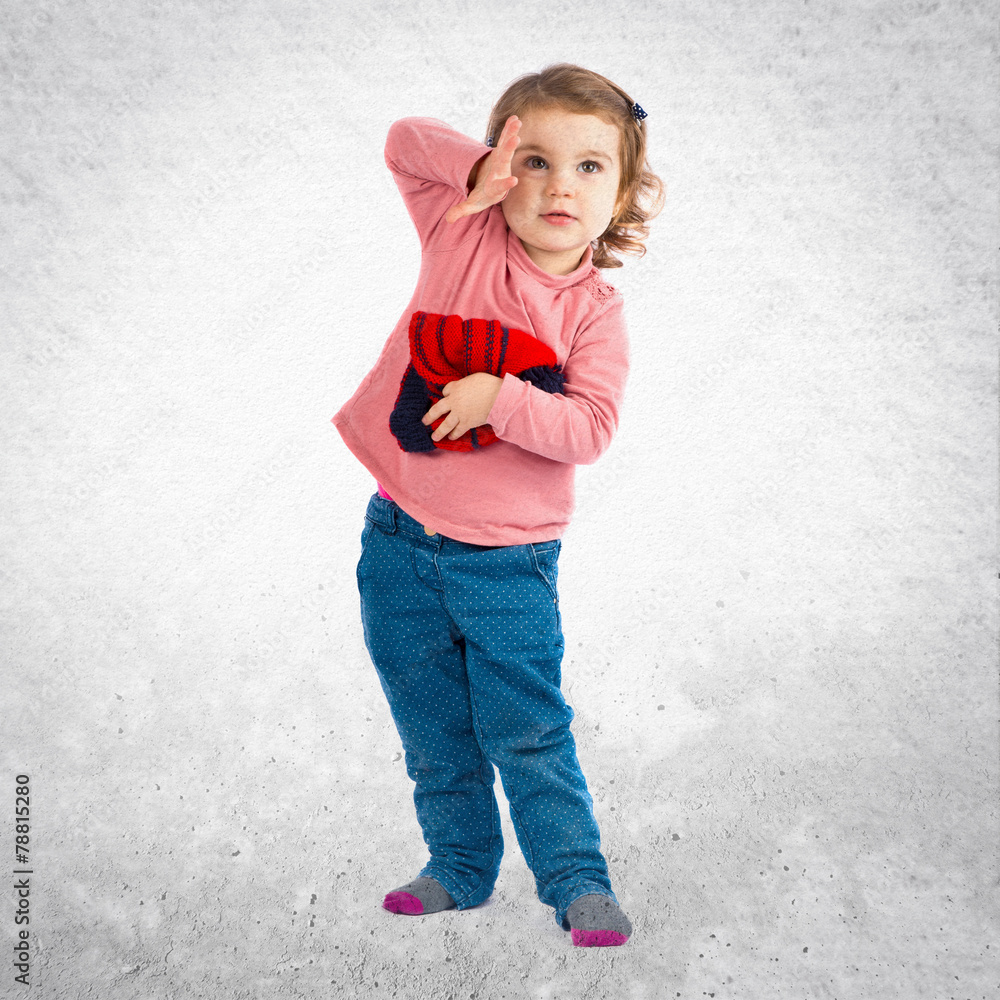 Little girl holding a Christmas hat over white background Little girl holding a Christmas hat over white background
