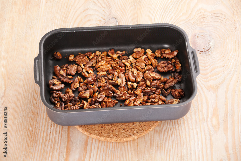 Obraz premium roasting walnuts in baking dish