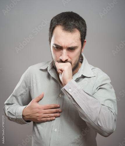 Strongly coughing young man suffered from asthma