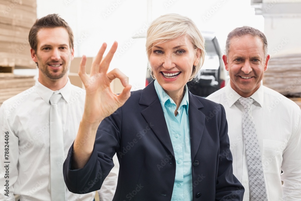 Smiling warehouse manager making okay gesture Smiling warehouse manager making okay gesture