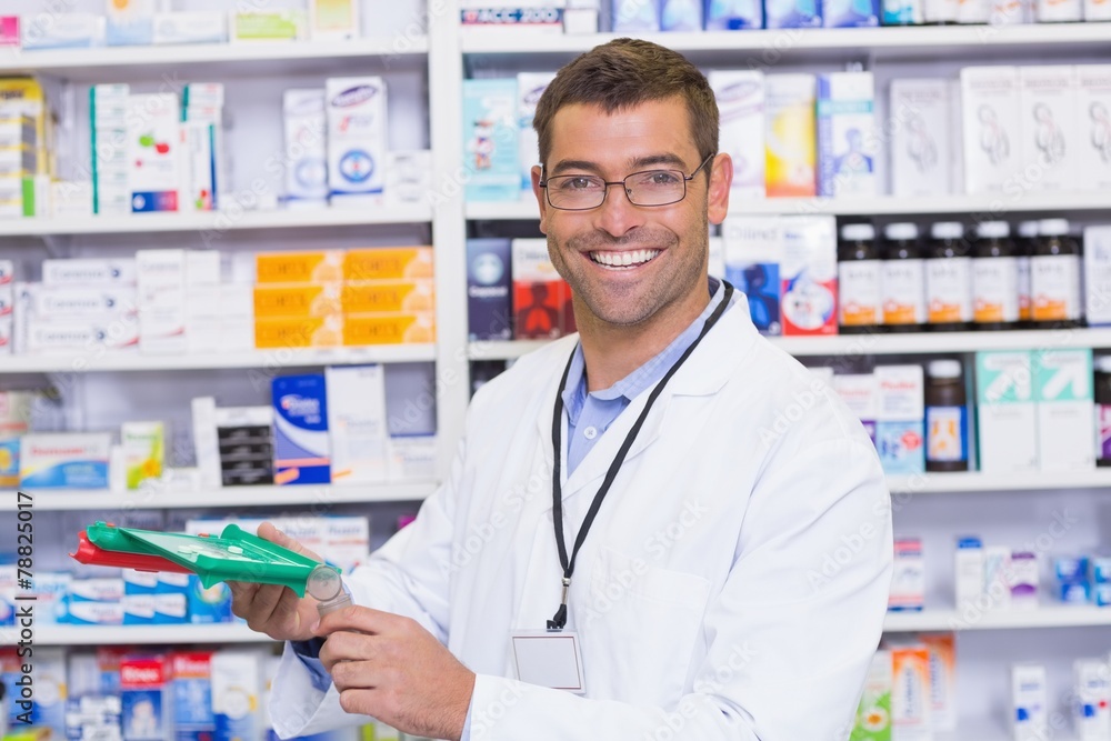 Handsome pharmacist holding medicine