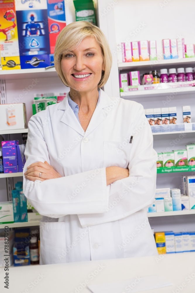 Smiling pharmacist with arms crossed