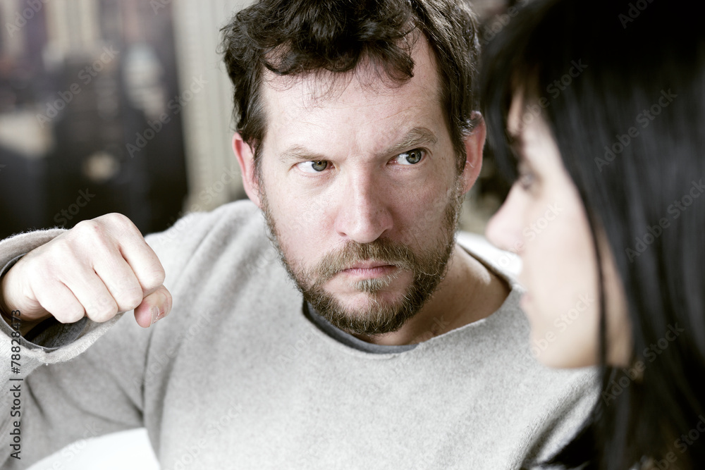 Fototapeta premium Man ready to punch girlfriend in face domestic violence