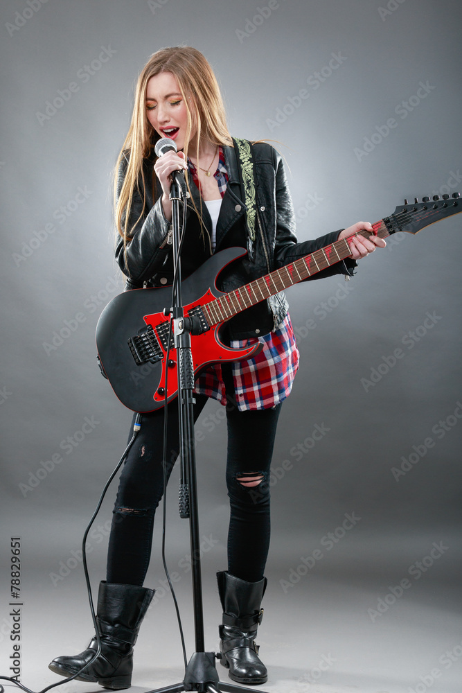 Beautiful young,blond woman with a electric guitar Beautiful young,blond woman with a electric guitar