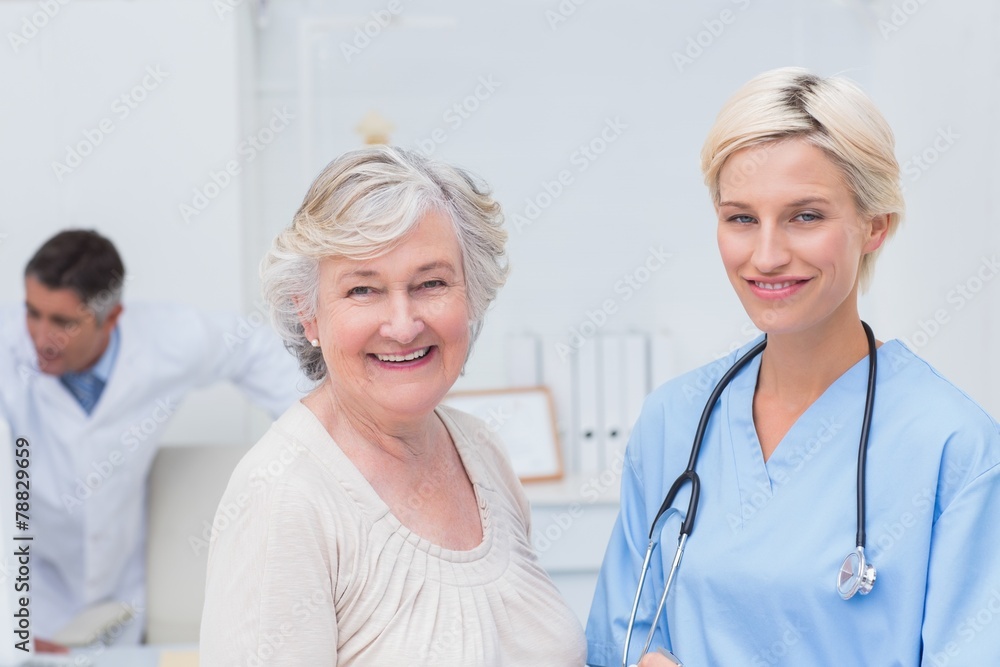Nurse and senior patient smiling in clinic Nurse and senior patient smiling in clinic
