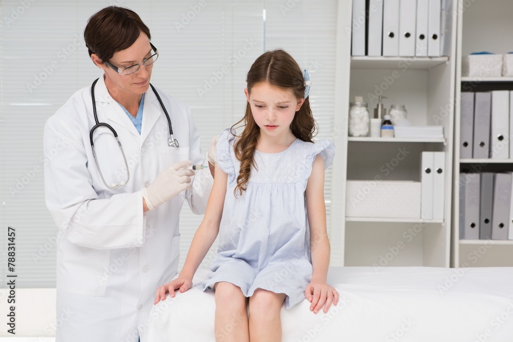 Doctor doing injection at a little girl Doctor doing injection at a little girl