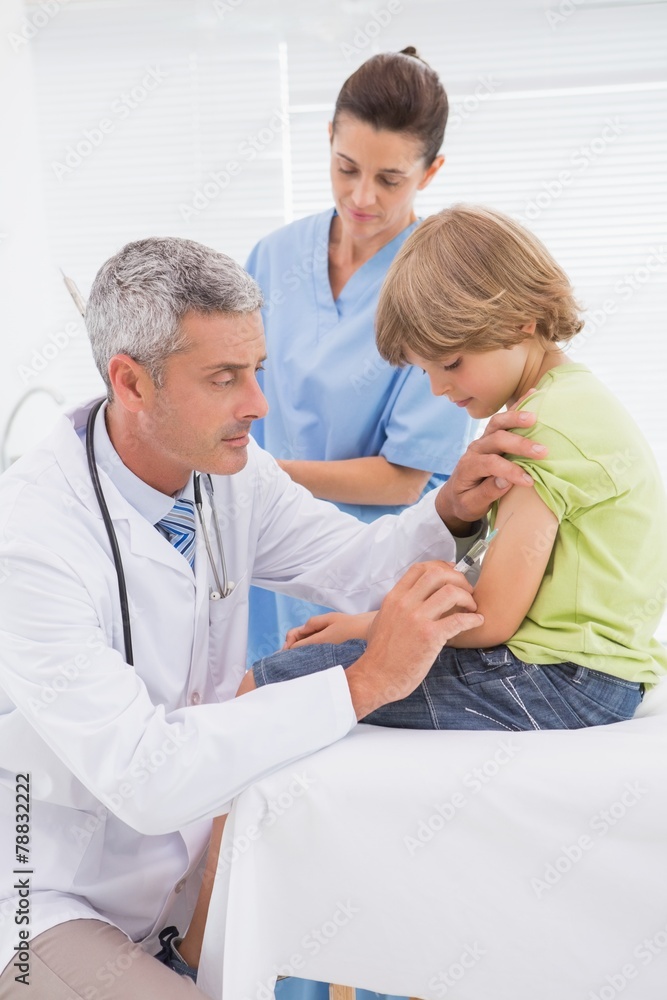 Obraz premium Doctor doing injection at little boy