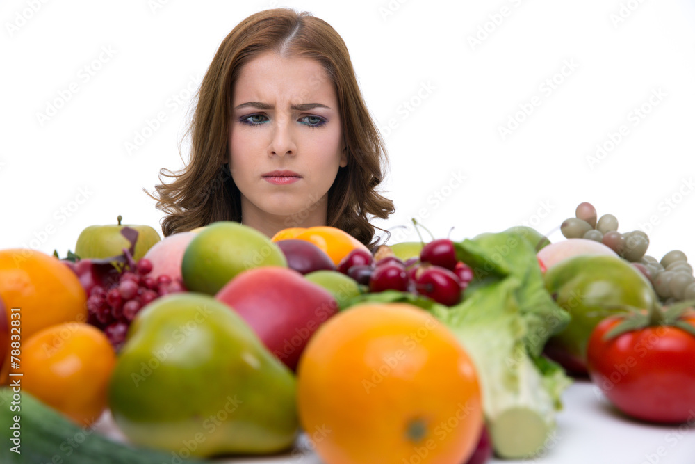 Portrait of a pensive woman looking on the fruits Portrait of a pensive woman looking on the fruits