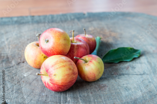 fresh red apples on wooden surface