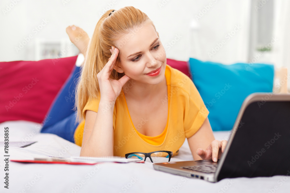 Young woman with her laptop in bed Young woman with her laptop in bed