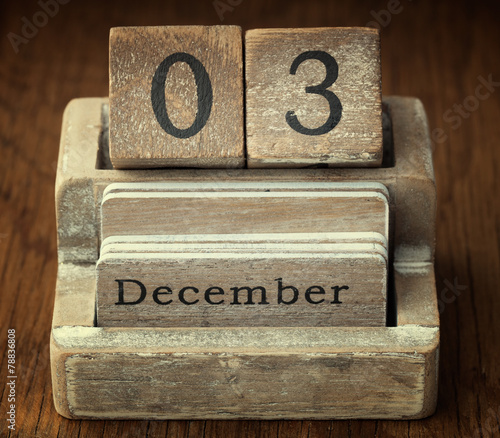 A very old wooden vintage calendar showing the date of 3rd Decem photo