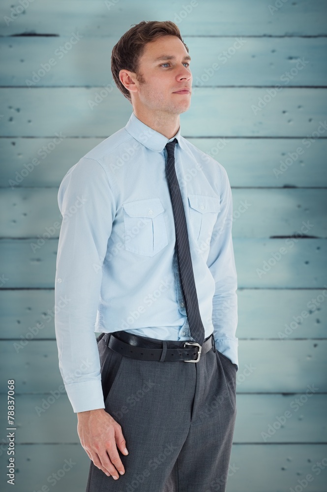 Serious businessman standing with hand in pocket