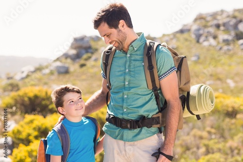 Father and son hiking through mountains