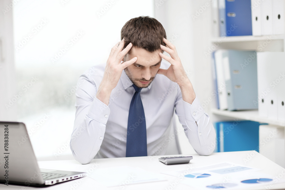 stressed businessman with laptop and documents stressed businessman with laptop and documents