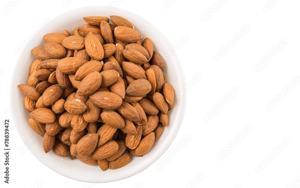 Raw almond nut in a white bowl over white background Raw almond nut in a white bowl over white background